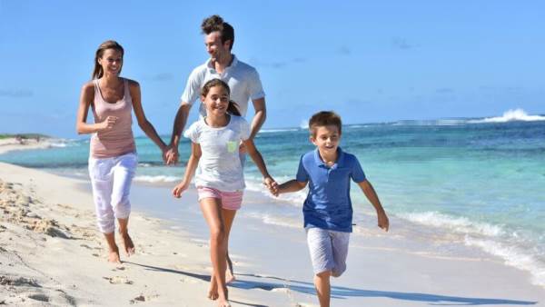 Family on vacation (stock photo), partially damaged and repaired by our technology. Can you see the difference?